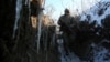 A Ukrainian soldier patrols along the front line with separatist forces in the east of the country.