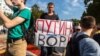 A protester holds a sign reading "Putin Is A Thief" during a rally against raising the retirement age, in Samara on September 9.