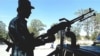 An Afghan policeman mans a machine gun in Ghazni province