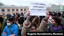 A demonstrator holds up a sign reading "Today they kill Navalny, tomorrow they kill me" during a rally in support of the jailed opposition leader in Moscow on April 21.