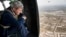 U.S. Secretary of State John Kerry looks out over Baghdad from a helicopter during a visit to the Iraqi capital on September 10. 
