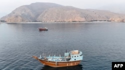 Boats lie anchored off Oman’s northern Musandam Peninsula near the Strait of Hormuz on June 27. 