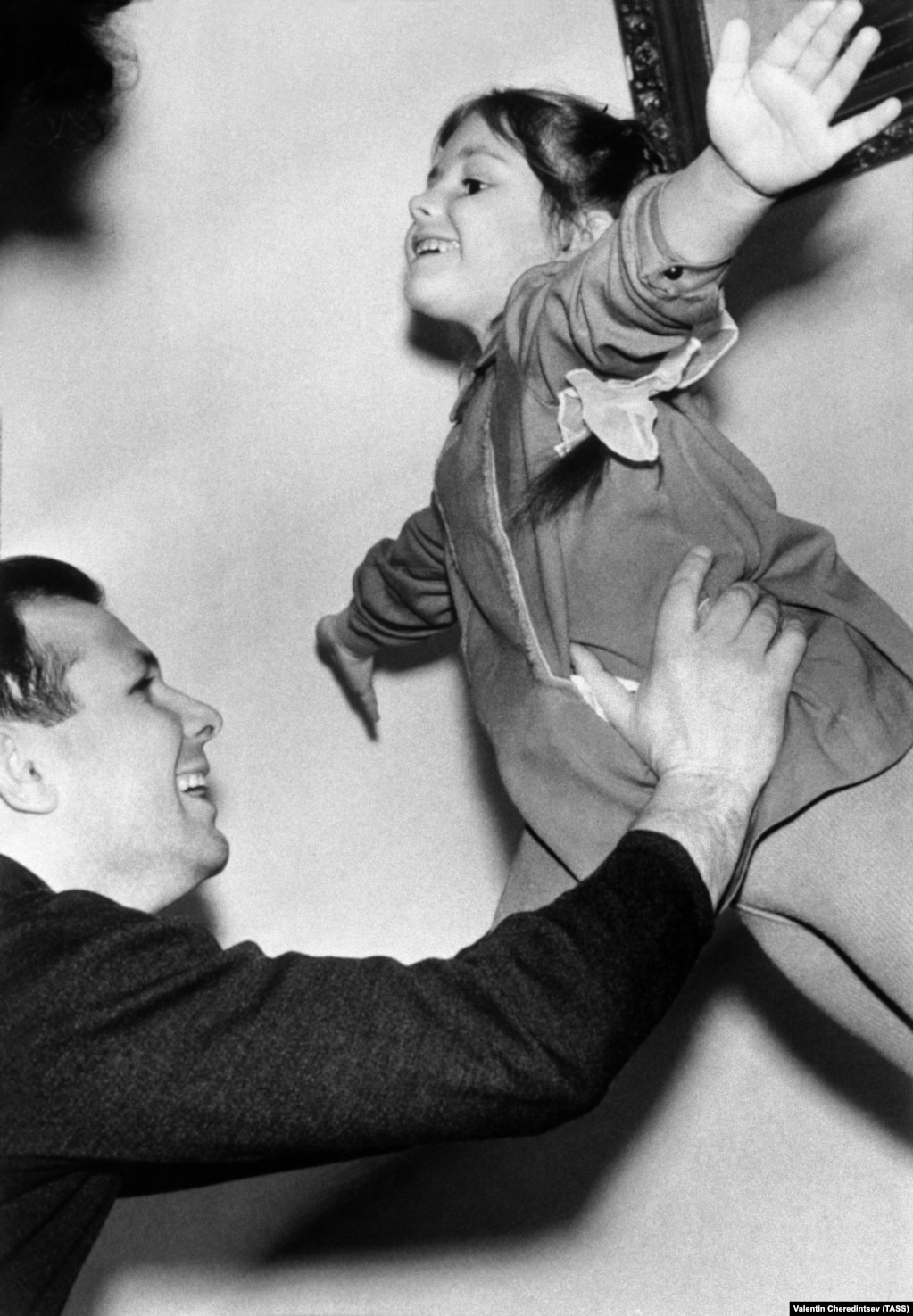 Gagarin plays with his daughter Yelena at home on March 10, 1964.
