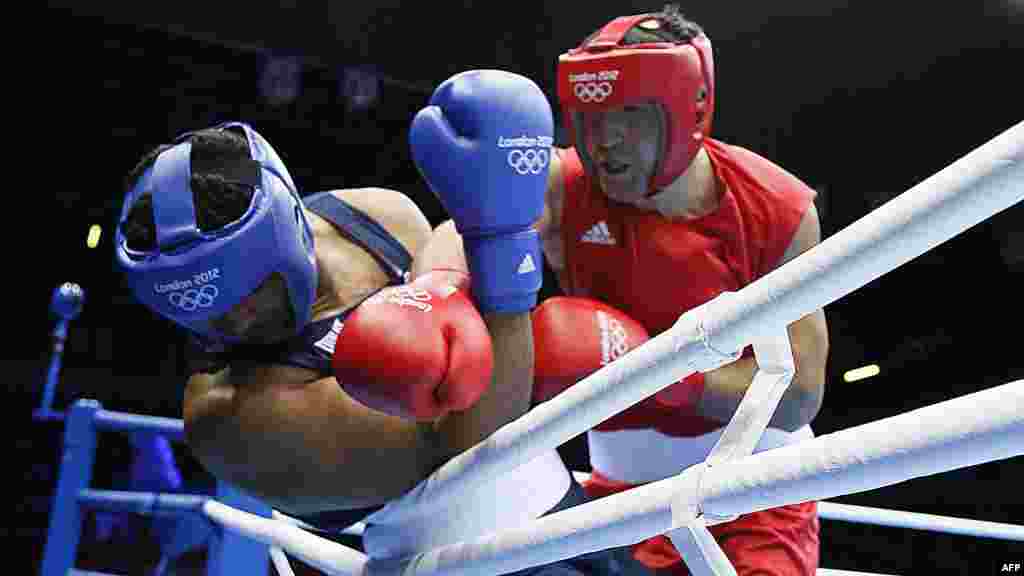 U.S. boxer Dominic Breazeale (left) tussles with Russian Magomed Omarov during their super-heavyweight bout in the Olympic boxing competition. (AFP/Jack Guez)