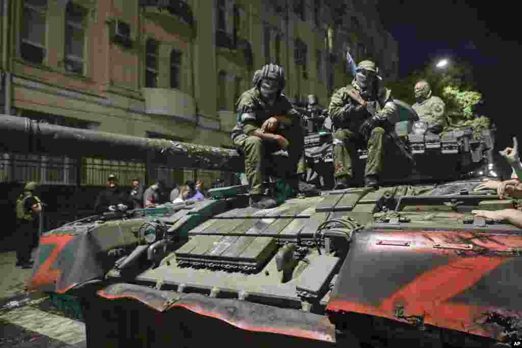 Members of Wagner sit atop a tank. &nbsp;