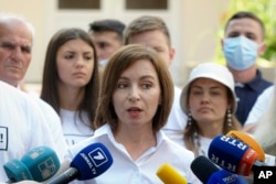 Moldovan President Maia Sandu speaks to the media after casting her vote on July 11.