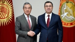 Chinese Foreign Minister Wang Yi (left) meets Kyrgyz President Sadyr Japarov in Bishkek on November 19 during a three-country tour of Central Asia. 