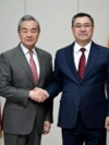 Chinese Foreign Minister Wang Yi (left) meets Kyrgyz President Sadyr Japarov in Bishkek on November 19 during a three-country tour of Central Asia. 