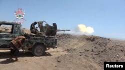 Saudi-backed Yemeni fighters fire a vehicle-mounted weapon during what government forces say was an advance against the Iran-aligned Houthis earlier this week.