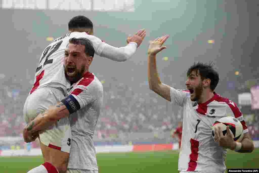 Georgia&#39;s Georges Mikautadze (left) celebrates with his teammates after scoring his team&#39;s opening goal during a match between Turkey and Georgia at the Euro 2024 soccer tournament in Dortmund, Germany, on June 18.