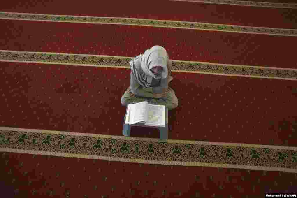 A boy reads the Koran ahead of the Muslim month of Ramadan, in Peshawar, Pakistan. (AP/Muhammad Sajjad)