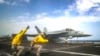 Lt. Nicholas Miller, from Spring, Texas, and Lt. Sean Ryan, from Gautier, Mississippi, launch an F/A-18E Super Hornet from the 'Pukin' Dogs' of Strike Fighter Squadron (VFA) 143 on the flight deck of the Nimitz-class aircraft carrier USS Abraham Lincoln. File phorto