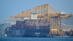 A Liberian-flagged container vessel is docked along a pier at the Khor Fakkan Container Terminal along the Gulf of Oman on June 28. Dispute over shipping in the Strait of Hormuz have led to tit-for-tat US and Iranian attacks.