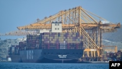 A Liberian-flagged container vessel is docked along a pier at the Khor Fakkan Container Terminal along the Gulf of Oman on June 28.