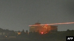 Afghanistan -- The Inter-Continental hotel in seen in the dark as tracer bullets are shot during an attack in Kabul, 29Jun2011