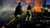 Firefighters work at a site of grain warehouses hit during a Russian drone strike in Uman in Ukraine's Cherkasy region on October 1.