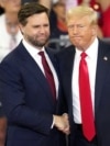 USA – Republican vice presidential candidate Sen. JD Vance, R-Ohio, left, and Republican presidential candidate former President Donald Trump, shake hands at a campaign rally at Georgia State University in Atlanta, Aug. 3, 2024