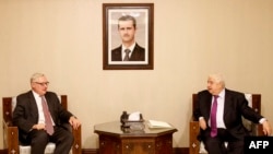 Russian Deputy Foreign Minister Sergei Ryabkov (left) meets with Syrian counterpart Walid al-Muallem in Damascus on September 17.
