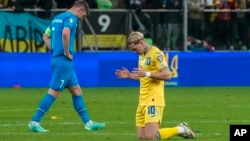 Ukraine's Mykhailo Mudryk (right) celebrates at the end of his country's victorious Euro 2024 playoff against Greece on March 26. 