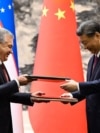 Uzbek President Shavkat Mirziyoyev (left) and Chinese President Xi Jinping attend a signing ceremony following talks in Beijing in January 2024 after agreeing to deepen their strategic partnership.