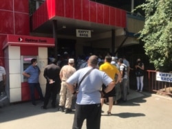 A long line for drugs at a pharmacy in Bishkek on July 13