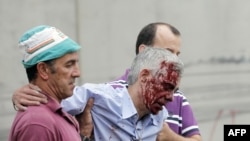 Train driver Francisco Jose Garzon Amo is helped away from the site of the tragedy on July 24.