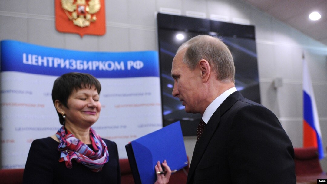 Russian Prime Minister Vladimir Putin (right) presents documentation for his candidacy in the 2012 presidential election, to a Central Electoral Commission official in Moscow on December 7.