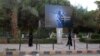 Women wearing a niqab, a type of full veil, walk under a billboard erected by the Islamic State (IS) group as part of a campaign in the IS-controlled Syrian city of Raqqa on November 2.