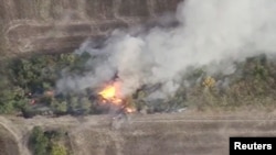 A still pictures from a drone footage shows military hardware on fire near Svitle