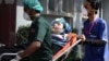 A person is rushed to a hospital for medical treatment in Karachi on February 19.