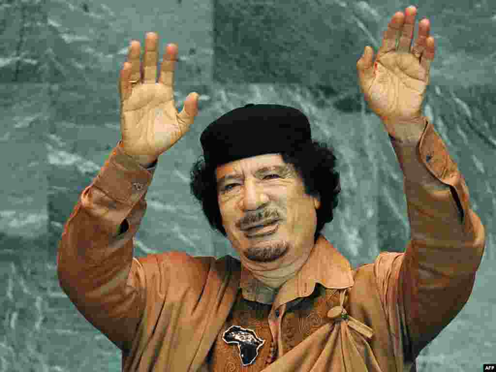 Qaddafi waves before delivering a long, rambling speech to the United Nations General Assembly on September 23, 2009 at UN headquarters in New York. It was his first speech to the General Assembly in his four-decade rule.