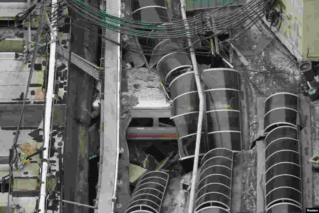 A New Jersey Transit train is seen under a collapsed roof after it derailed and crashed into the station in Hoboken, New Jersey. One person was killed and 100 others injured. (Reuters/Carlo Allegri)