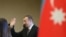 Azerbaijan -- President Ilham Aliyev waves after casting his ballot at a polling station in Baku, October 9, 2013