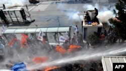 Turkish riot police use water cannon during the October 6 protests.