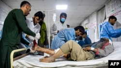 Afghan medical personnel treat a wounded man at a hospital in the aftermath of the earthquake that struck overnight in Mazar-e-Sharif on November 3.