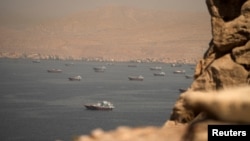Dozens of commercial vessels crossed the Strait of Hormuz on June 18, according to tracking data.