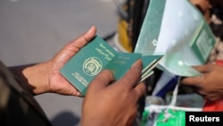 A Border Security Force (BSF) soldier checks the passports of Pakistan citizens as they prepare to leave India after India revoked all visas issued to Pakistani citizens
