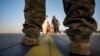 A U.S. Marine provides security for evacuees boarding a U.S. Air Force plane at Hamid Karzai International Airport in Kabul on August 24.