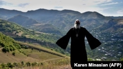 Armenia -- Priest Ter Abel prays for peace outside the village of Movses on the Armenian-Azerbaijani border, July 15, 2020