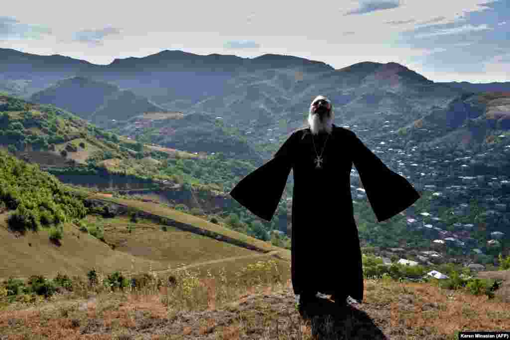 After recent fighting on the&nbsp;Armenian-Azerbaijani border between the two countries, an Armenian priest prays for peace outside the village of Movses. (AFP/Karen Minasyan)