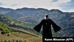 Armenia -- Priest Ter Abel prays for peace outside the village of Movses on the Armenian-Azerbaijani border, July 15, 2020