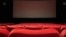 red cinema seats in an empty movie theater