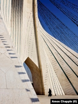 A woman walking through the Azadi Tower in December 2011.