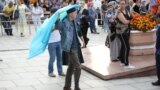 Kazakhstan - A man demonstrates a Kazakh state flag during a protest rally held by opposition supporters in Almaty, Kazakhstan July 6, 2019. REUTERS/Pavel Mikheyev