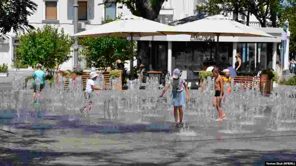 Дети купаются в фонтане на площади Ушакова в Севастополе