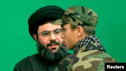 Lebanon -- Jihad Moughniyah (R), son of Lebanon's Hizballah late military leader Imad Moughniyah, greets Sayyed Hashem Safieddine, head of Hizballah's Executive Council, as they attend a ceremony marking a week of his father's death.