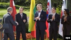 U.S. President Bush greets envoys from Lithuania, Estonia, and Slovakia with Secretary of State Condoleezza Rice (left to right) looking on at the White House on October 17