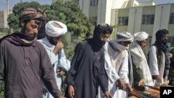 Taliban fighters hand over their weapons in Herat in September.