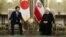 Iranian President Hassan Rohani (right) meets with Japanese Prime Minister Shinzo Abe in Tehran on June 12.