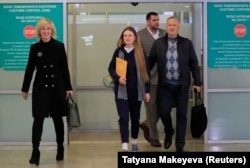 Maria Butina (center) served more than a year in a U.S. prison after pleading guilty to charges stemming from a years-long effort to befriend U.S. political operatives. Ionov helped pay for her lawyers.